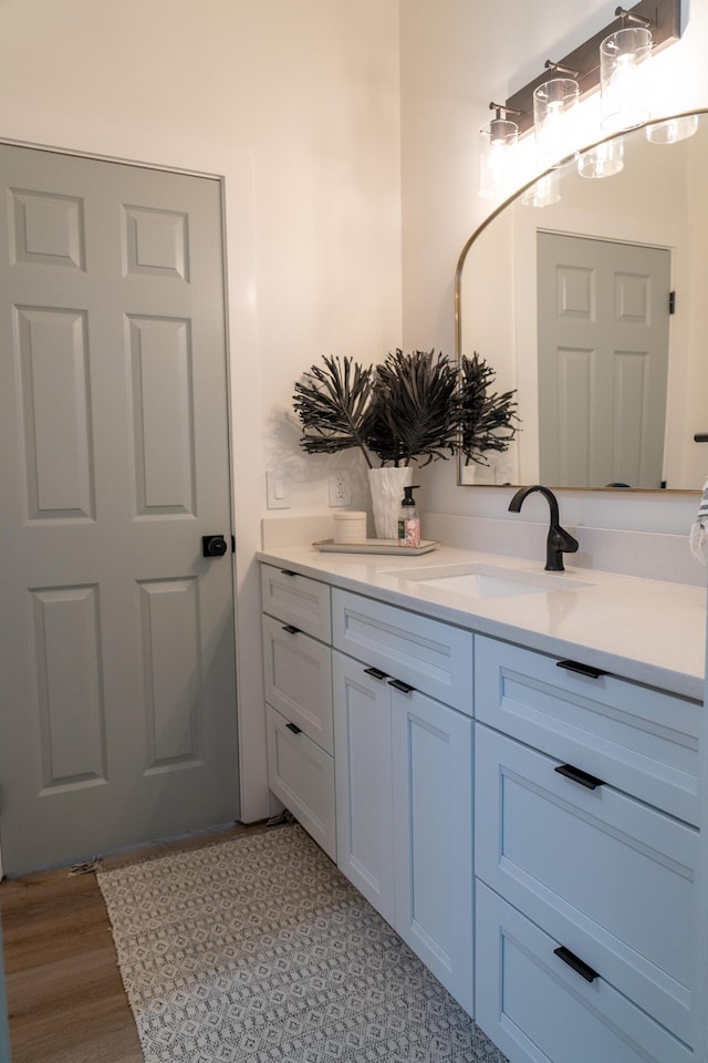 bathroom with vanity and hardwood / wood-style floors