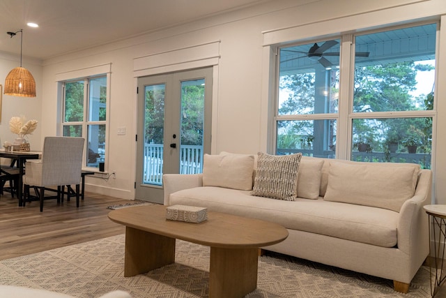 living room with crown molding, hardwood / wood-style flooring, and french doors