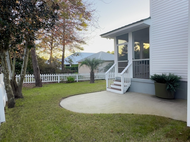 view of yard featuring a patio area and a sunroom