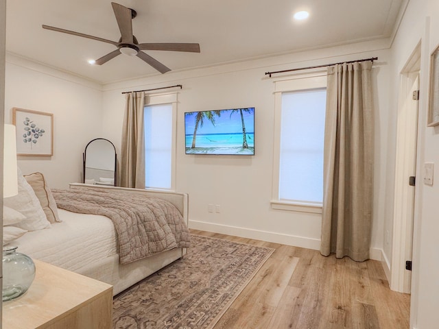 bedroom with ceiling fan, ornamental molding, and light wood-type flooring