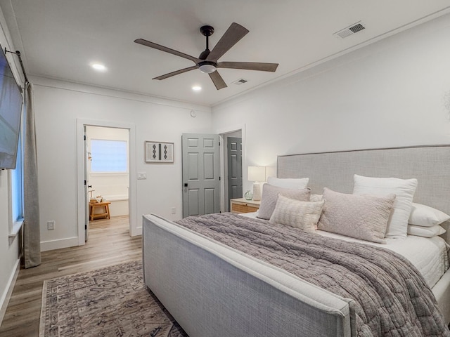 bedroom featuring hardwood / wood-style flooring, ornamental molding, and ceiling fan