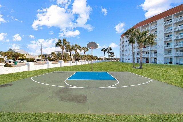 view of sport court featuring a yard