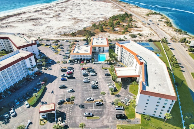 birds eye view of property featuring a beach view and a water view