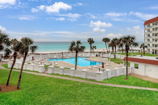 view of pool with a lawn, a patio, and a water view