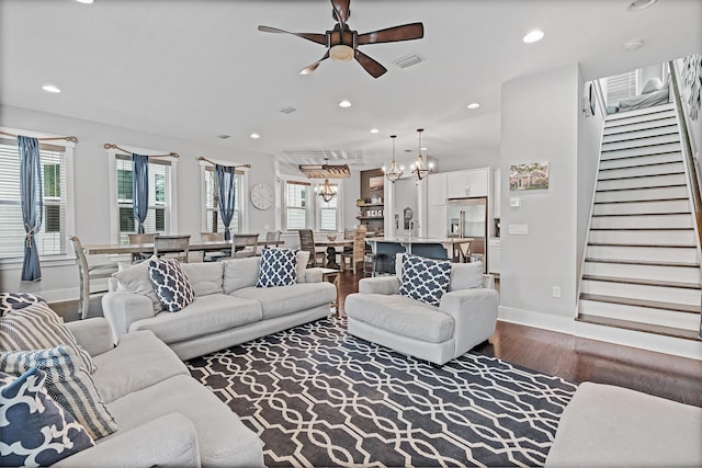 living room with hardwood / wood-style flooring, sink, a healthy amount of sunlight, and ceiling fan with notable chandelier