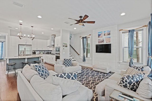 living room with ceiling fan and wood-type flooring