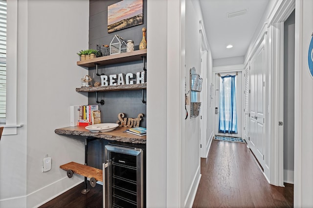 corridor with wine cooler and dark hardwood / wood-style flooring