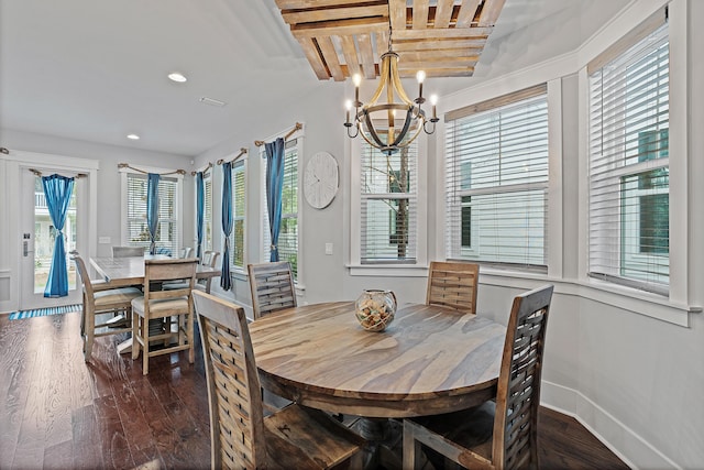 dining room featuring an inviting chandelier, plenty of natural light, and dark hardwood / wood-style floors