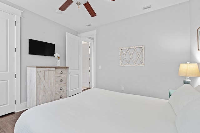 bedroom with dark wood-type flooring and ceiling fan