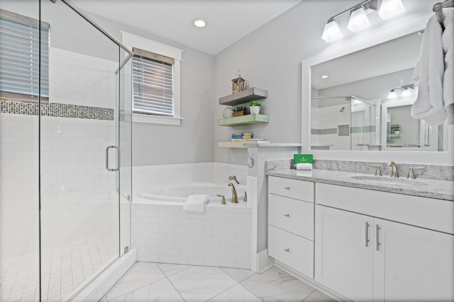 bathroom featuring vanity and separate shower and tub