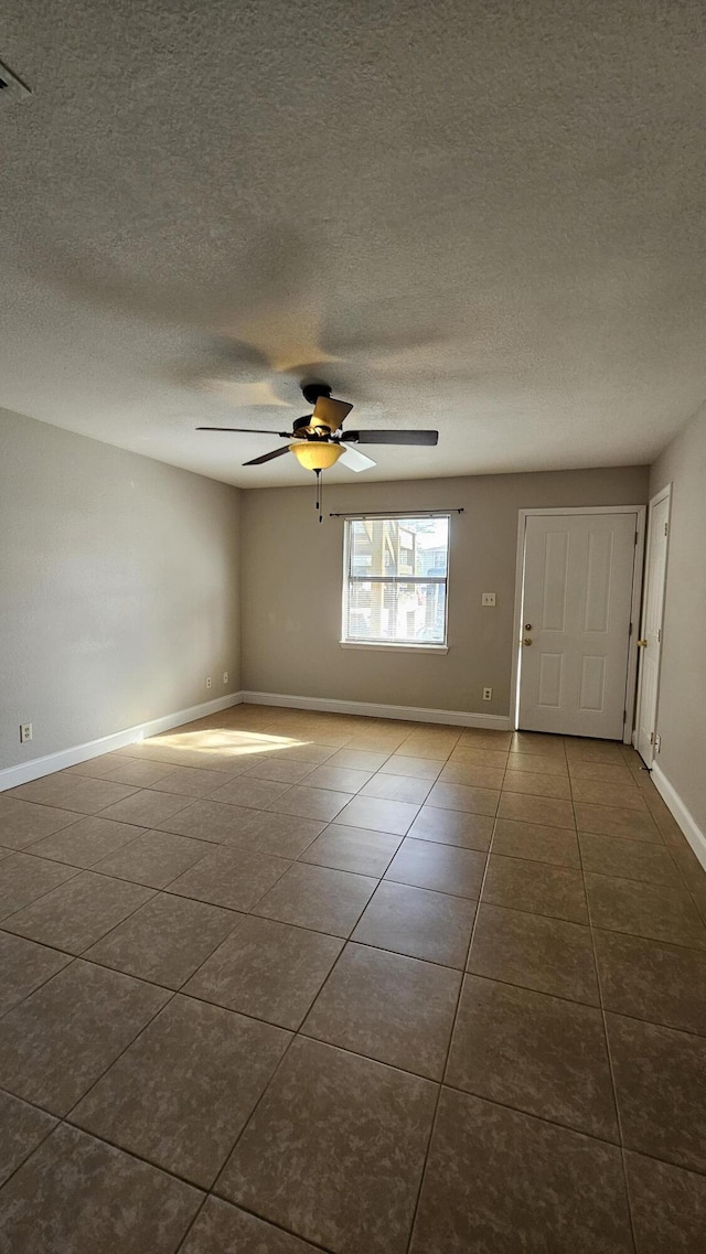 tiled empty room with ceiling fan