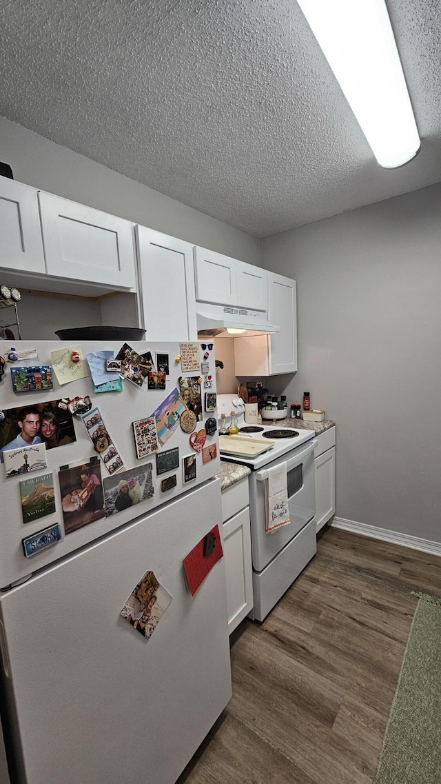 kitchen with white appliances, a textured ceiling, dark hardwood / wood-style floors, and white cabinets