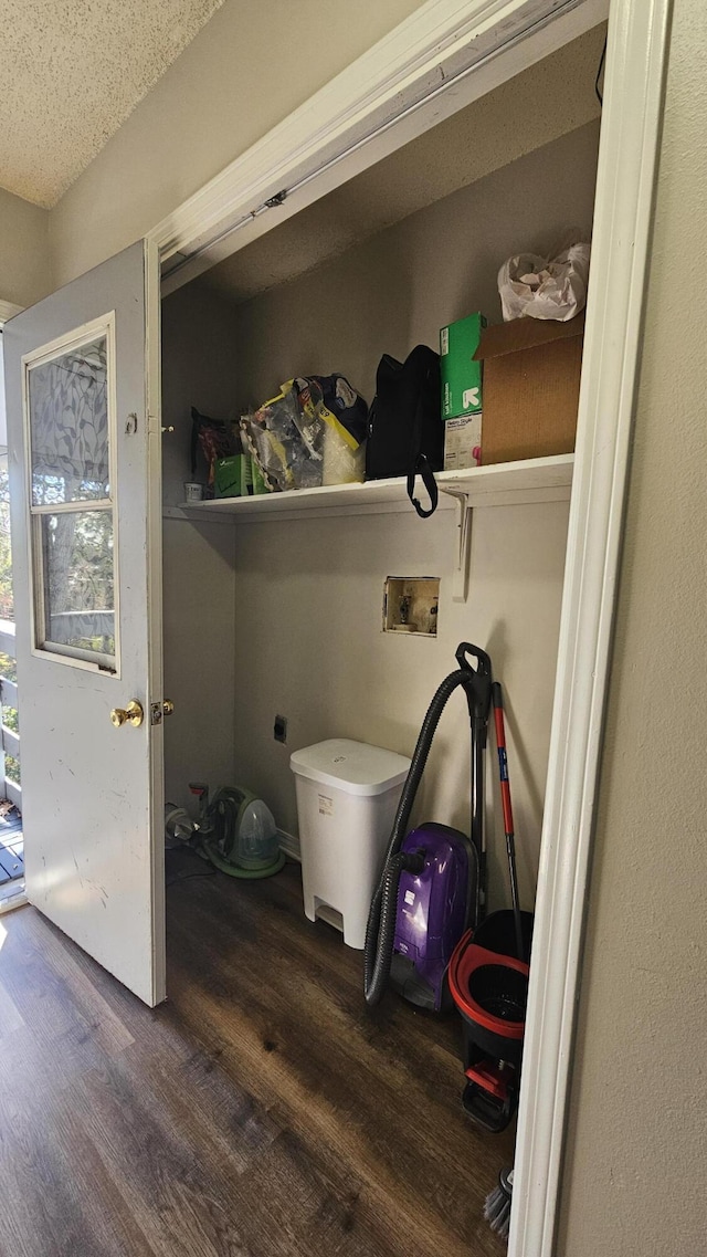 laundry room featuring washer hookup, dark hardwood / wood-style flooring, hookup for an electric dryer, and a textured ceiling