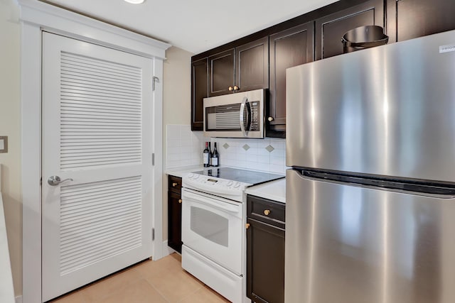 kitchen featuring tasteful backsplash, dark brown cabinetry, appliances with stainless steel finishes, and light tile patterned floors