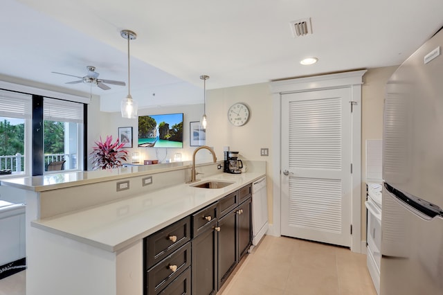 kitchen with sink, hanging light fixtures, stainless steel fridge, kitchen peninsula, and white dishwasher