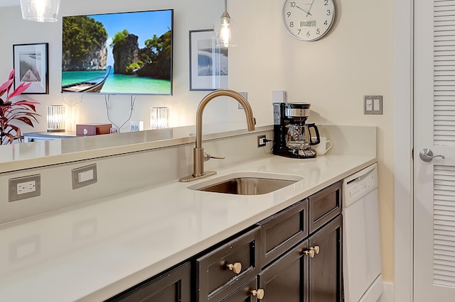 kitchen featuring sink, decorative light fixtures, dark brown cabinets, and dishwasher