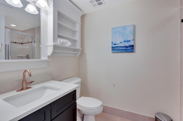 bathroom with tile patterned flooring, vanity, an enclosed shower, and toilet