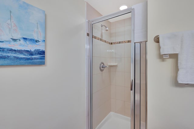 bathroom featuring a shower with door