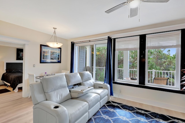 living room with hardwood / wood-style flooring, ceiling fan, and a healthy amount of sunlight