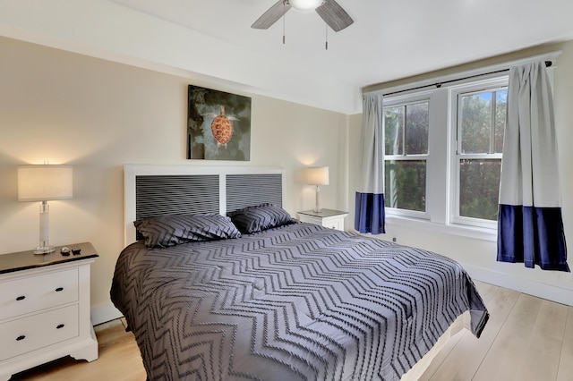 bedroom with ceiling fan and light hardwood / wood-style floors