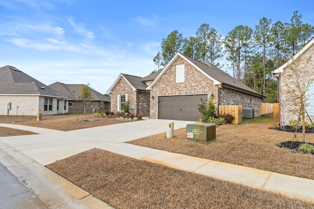 view of front facade featuring a garage and central AC