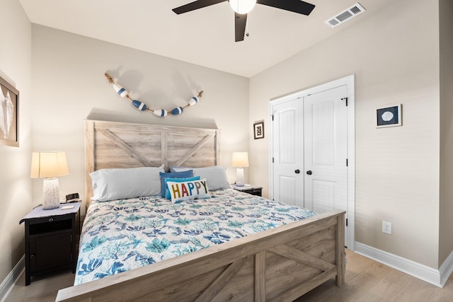 bedroom featuring ceiling fan, a closet, and light hardwood / wood-style flooring