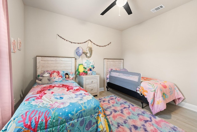 bedroom with light hardwood / wood-style floors and ceiling fan