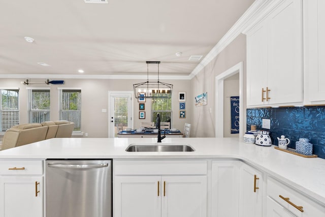 kitchen featuring sink, white cabinets, ornamental molding, stainless steel dishwasher, and kitchen peninsula