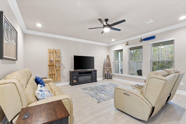 living room with ornamental molding, ceiling fan, and light hardwood / wood-style floors