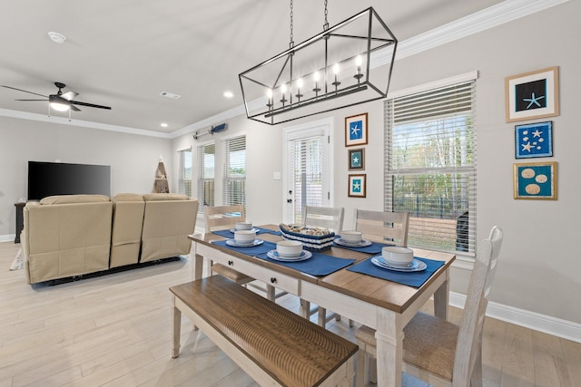 dining space with crown molding, ceiling fan, and light hardwood / wood-style floors