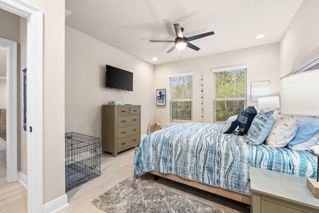 bedroom with ceiling fan and light hardwood / wood-style floors