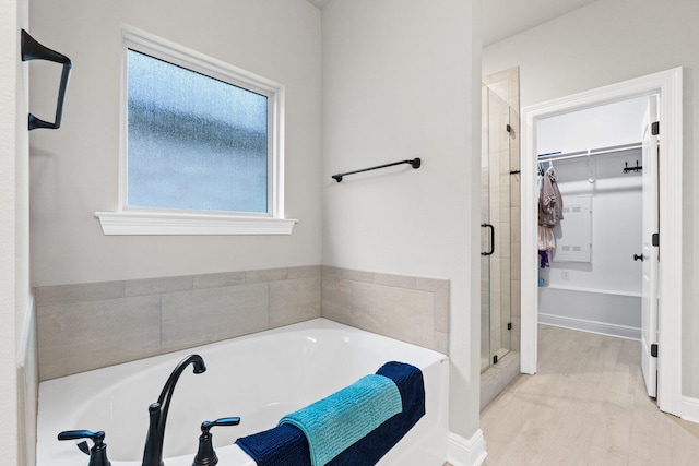 bathroom featuring a shower with shower door and wood-type flooring