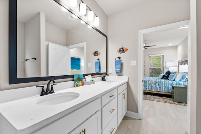 bathroom with hardwood / wood-style flooring, vanity, and ceiling fan