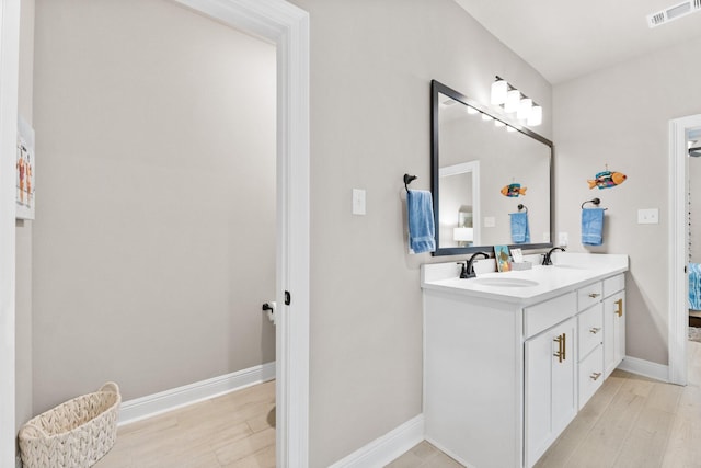 bathroom with vanity and wood-type flooring