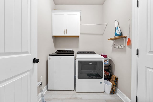 laundry area with cabinets and washer and clothes dryer