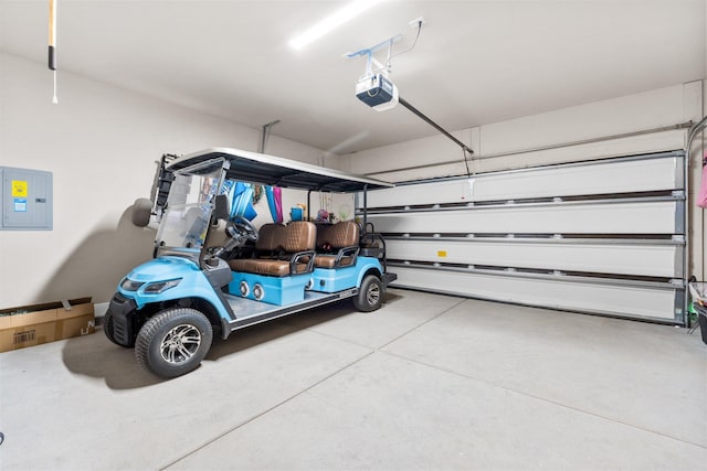 garage with a garage door opener and electric panel