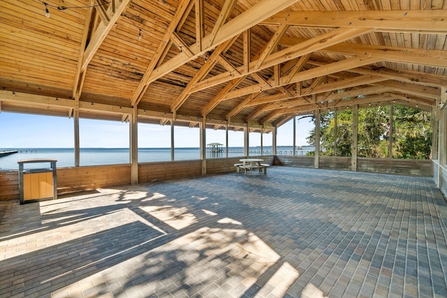 interior space with a water view and vaulted ceiling