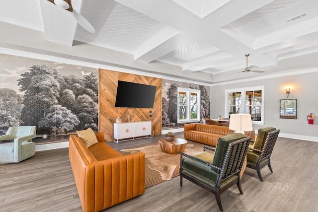 living room with hardwood / wood-style floors, wood walls, coffered ceiling, ceiling fan, and beam ceiling