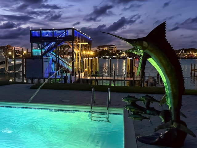 pool at dusk with a water view