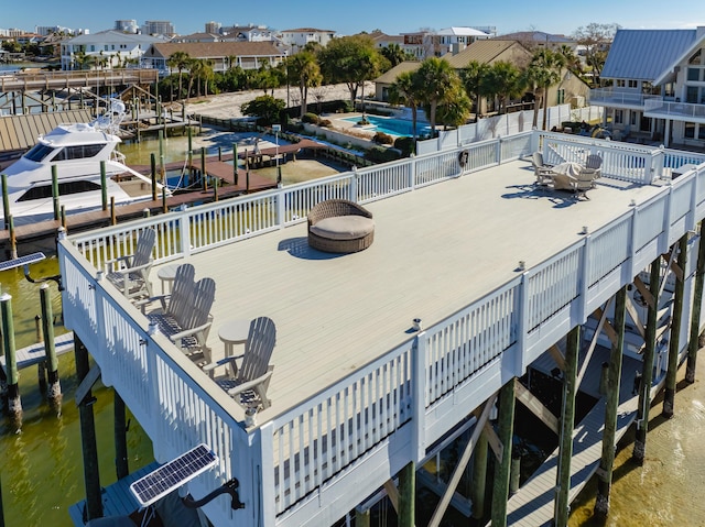 exterior space featuring a water view and an outdoor fire pit