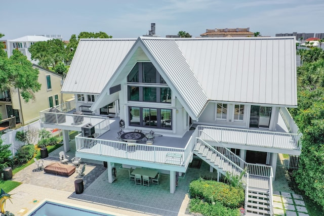 back of house featuring a fire pit and a patio area