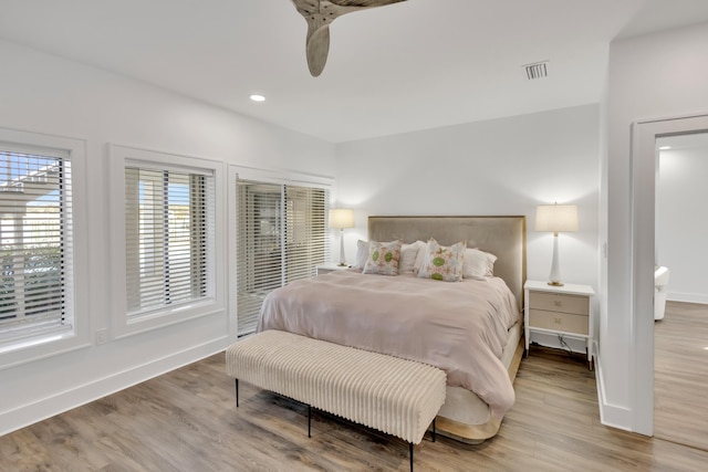 bedroom featuring hardwood / wood-style floors and access to exterior