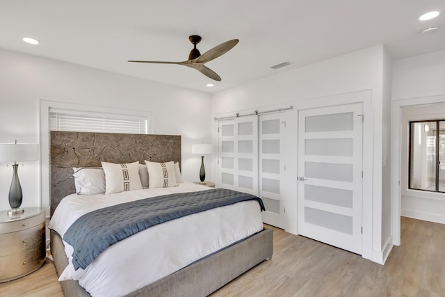 bedroom with ceiling fan and light hardwood / wood-style floors