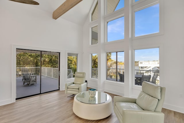 sunroom featuring plenty of natural light and lofted ceiling with beams