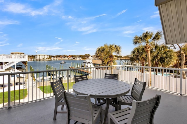 view of patio featuring a water view and a balcony