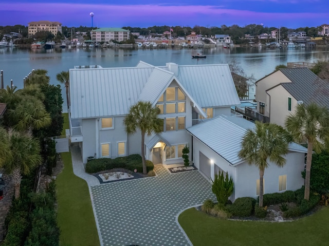 aerial view at dusk with a water view