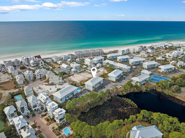 bird's eye view with a water view and a view of the beach