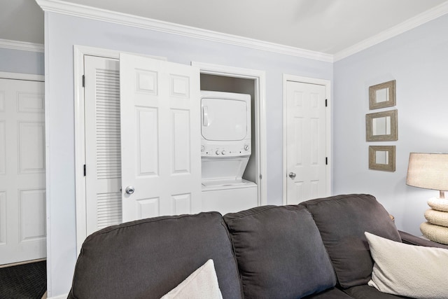 living room with ornamental molding and stacked washer and clothes dryer