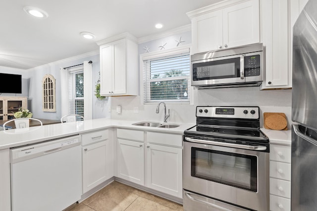 kitchen featuring sink, appliances with stainless steel finishes, white cabinetry, ornamental molding, and light tile patterned flooring