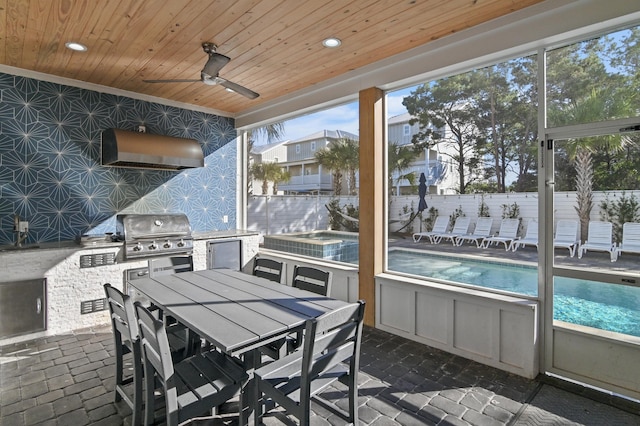 sunroom / solarium featuring ceiling fan and wood ceiling